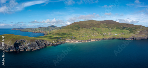 landscape view of the turquoise waters and golden sand beach at Slea Head on the Dingle Peninsula of County Kerry