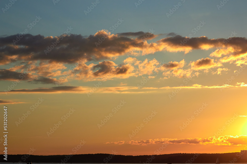 Beautiful sunset. Sunset over the water. The sun sets over a large lake.