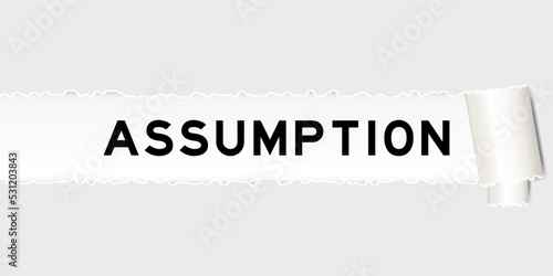 Ripped gray paper background that have word assumption under torn part