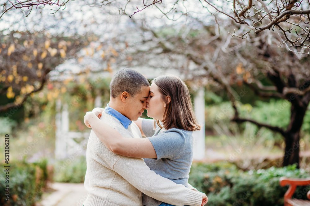 Lgbtqi couple being intimate and hugging each other with trees in the background Lgbtqi couple being intimate and hugging each other with trees in the background