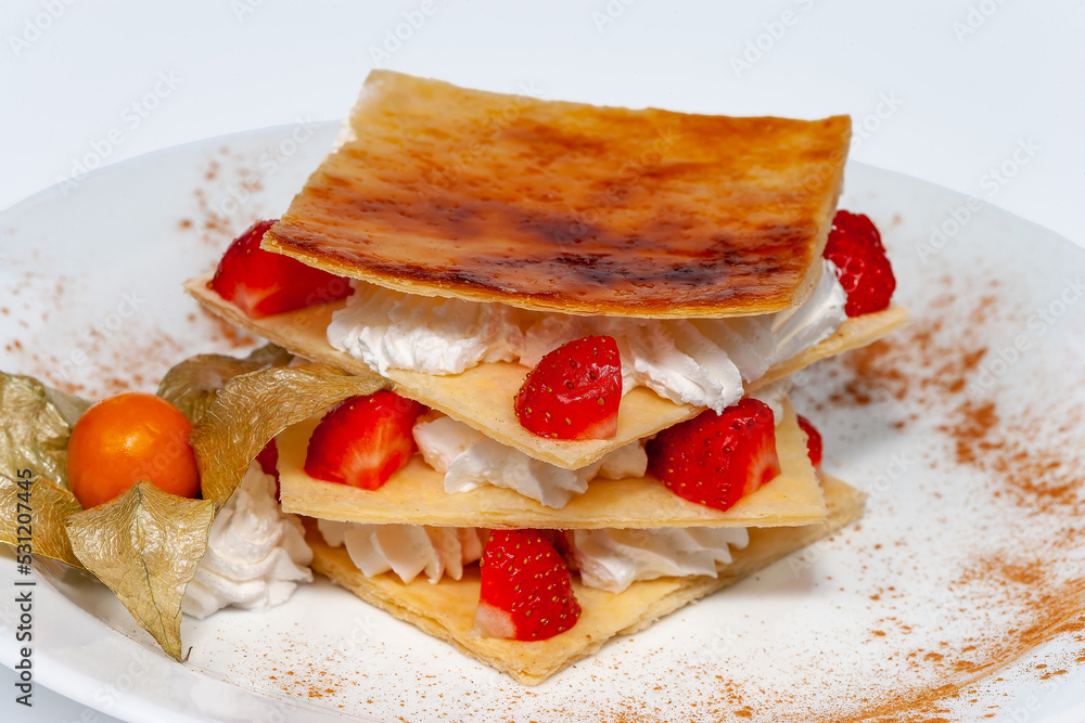 Italian dessert strawberry milfey, made of vanilla cream and fresh strawberries Italian dessert strawberry milfey, made of vanilla cream and fresh strawberries