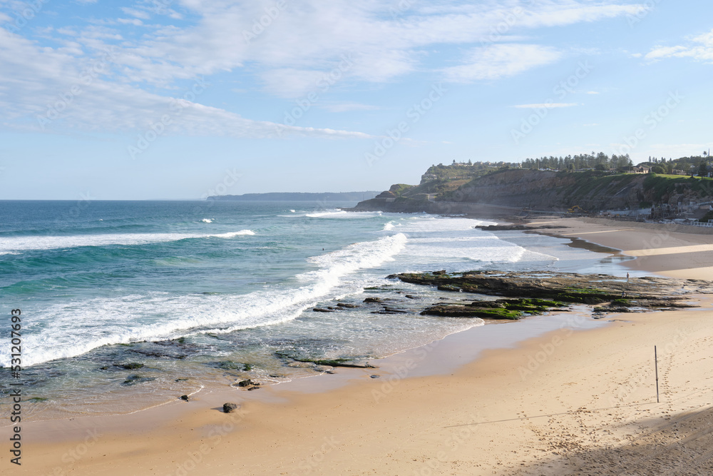 A photograph of waves crashing over Newcastle Beach and rock pools taken in Winter 2022