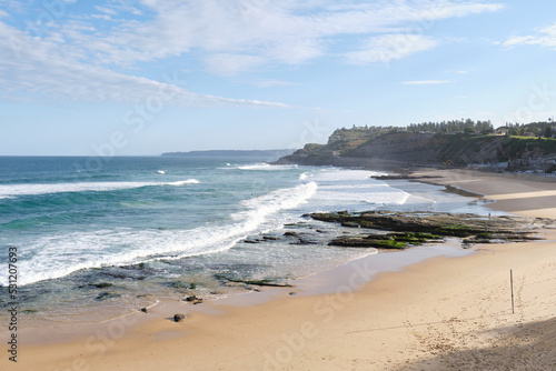 A photograph of waves crashing over Newcastle Beach and rock pools taken in Winter 2022