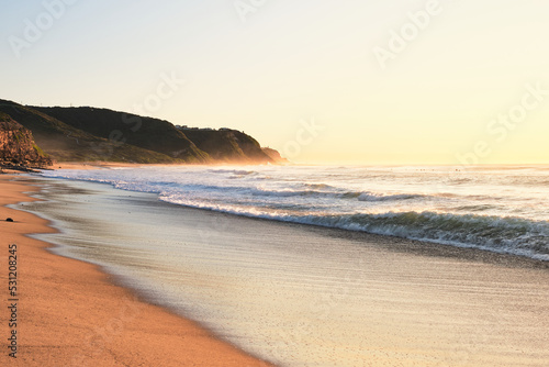 Ocean waves washing in over Burwood beach, New South Wales, Australia during sunrise