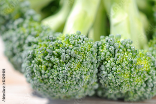 Broccoli cabbage on a light background before cooking closeup. Shallow depth of field