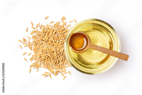 Rice bran oil with paddy rice isolated on white background, Top view, Flat lay. photo