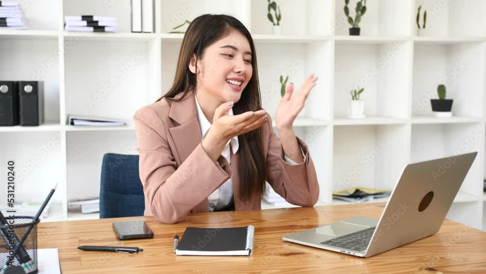Asian businesswoman chatting with customers via laptop online Asian businesswoman chatting with customers via laptop online
