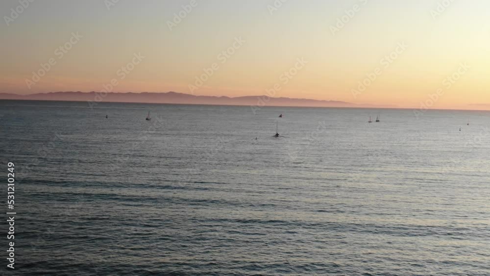 High aerial over pacific ocean off of Santa Barbara coastline with Channel Islands in distance at sunset High aerial over pacific ocean off of Santa Barbara coastline with Channel Islands in distance at sunset