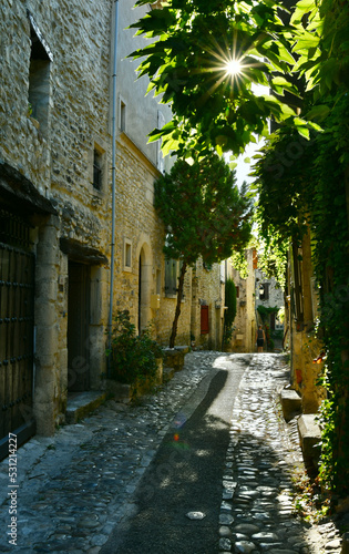 Narrow street of Vaison-la-romaine french old town on a hill.