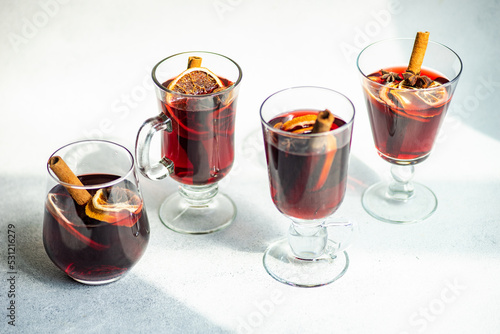 Close-up of four glasses of mulled wine with spices on a table photo