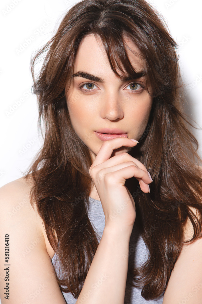Girl without makeup in a gray top on a light background Girl without makeup in a gray top on a light background