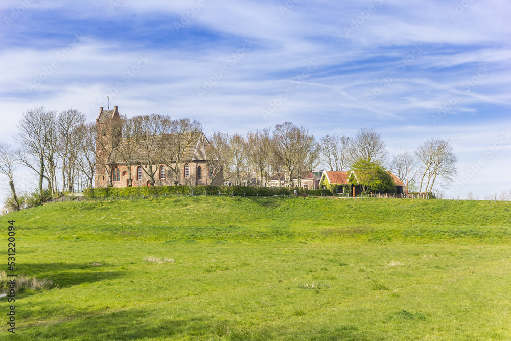 Obraz premium Church and houses on top of the mound in Hegebeintum, Netherlands