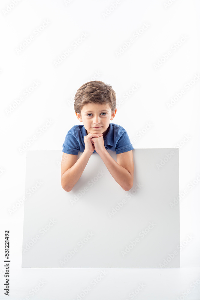 Funny child showing a white advertising poster with space for text. Funny child showing a white advertising poster with space for text.