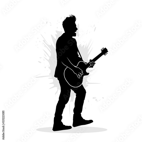 Silhouette of man playing guitar on stage