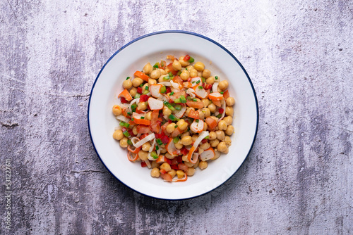 Chickpea salad with crab and vegetables. Cold salad typical Spanish cuisine.