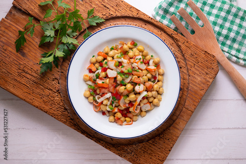 Chickpea salad with crab and vegetables. Cold salad typical Spanish cuisine.