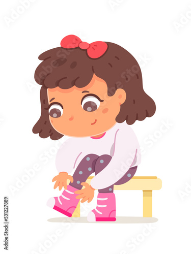 Girl tying shoelaces, cute independent crouched child learning to tie laces on sneakers