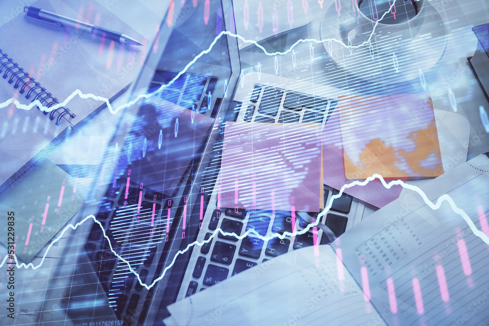 Fototapeta premium Multi exposure of financial chart drawing over table background with computer. Concept of research and analysis. Top view.