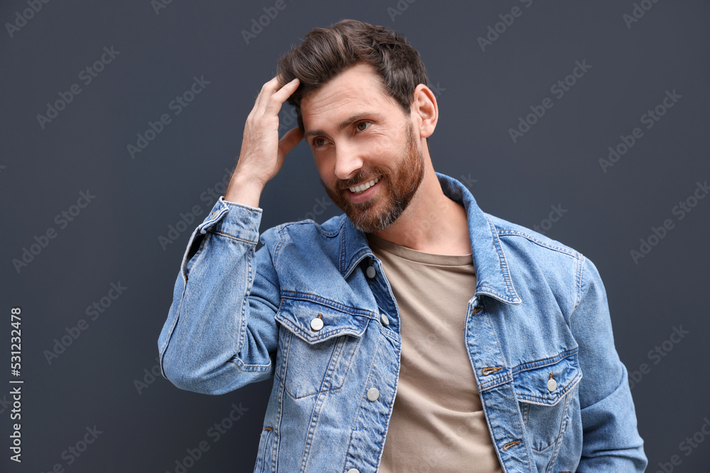 Portrait of smiling handsome bearded man on grey background Portrait of smiling handsome bearded man on grey background