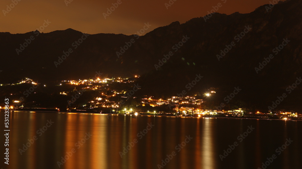 City with a sea and light on the water at night