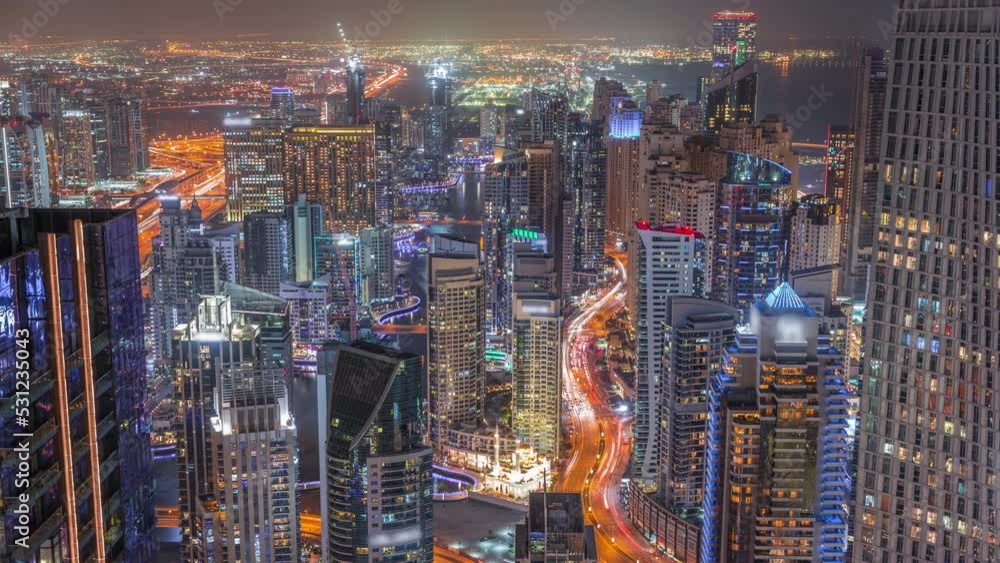 Skyline panoramic view of Dubai Marina showing canal surrounded by skyscrapers along shoreline day to night timelapse. DUBAI, UAE Skyline panoramic view of Dubai Marina showing canal surrounded by skyscrapers along shoreline day to night timelapse. DUBAI, UAE