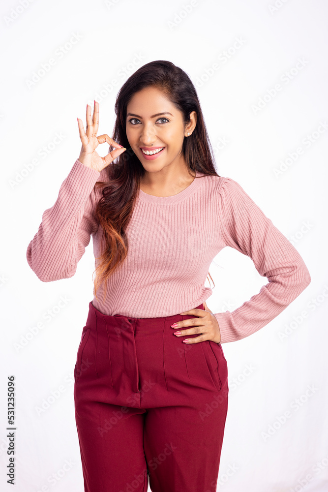 Young business woman showing hand sign isolated on white. Young business woman showing hand sign isolated on white.