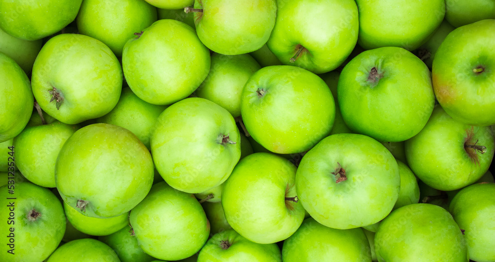 Green apples background. Lots of homemade natural apples. Healthy organic fresh food. Proper nutrition and vitamins. Green apples background. Lots of homemade natural apples. Healthy organic fresh food. Proper nutrition and vitamins.