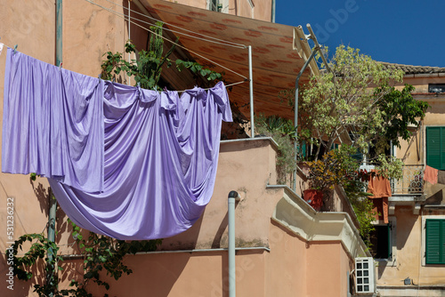 Charming old townhouses in the center of corfu town. Laundry on the ropes in the foreground © MAXSHOT_PL