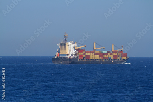 A merchant ship underway at sea in calm weather