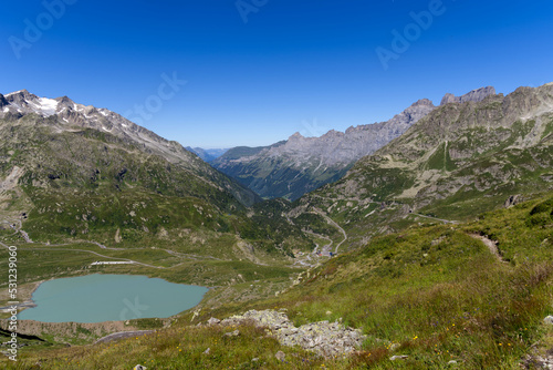 Beautiful scenic aerial view of mountain panorama at Swiss mountain pass Susten with glacier lake on a sunny summer day. Photo taken July 13th  2022  Susten Pass  Switzerland.