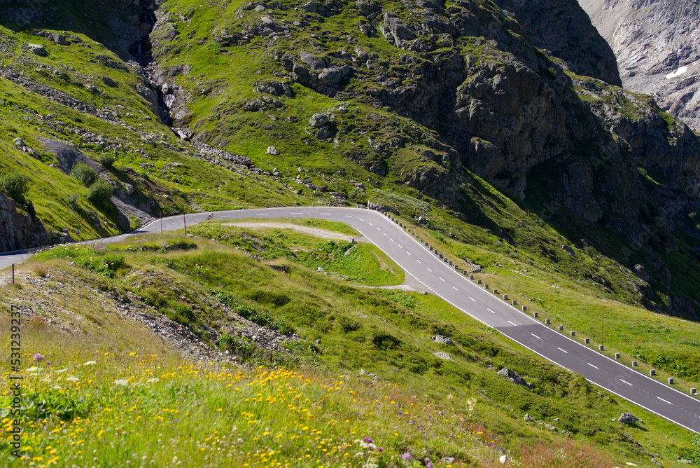 Aerial view of Swiss mountain pass road of Susten Pass with cyclist on a sunny summer day. Photo taken July 13th, 2022, Susten Pass, Switzerland. Aerial view of Swiss mountain pass road of Susten Pass with cyclist on a sunny summer day. Photo taken July 13th, 2022, Susten Pass, Switzerland.