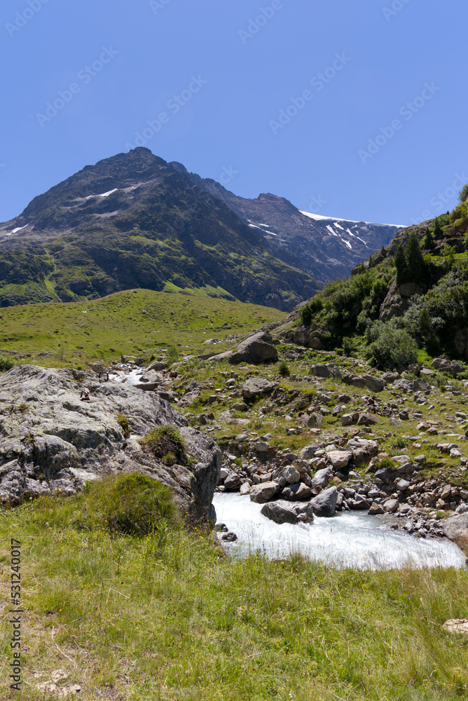 Beautiful scenic view of Stone Glacier at Swiss mountain pass Sustenpass with glacier river in the foreground on a sunny summer day. Photo taken July 13th, 2022, Susten Pass, Switzerland.