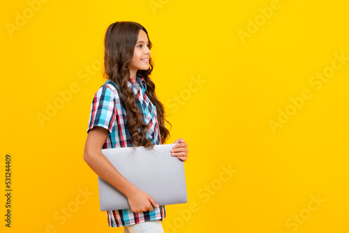 Young student school girl, studying with laptop computer. E-learning concept.