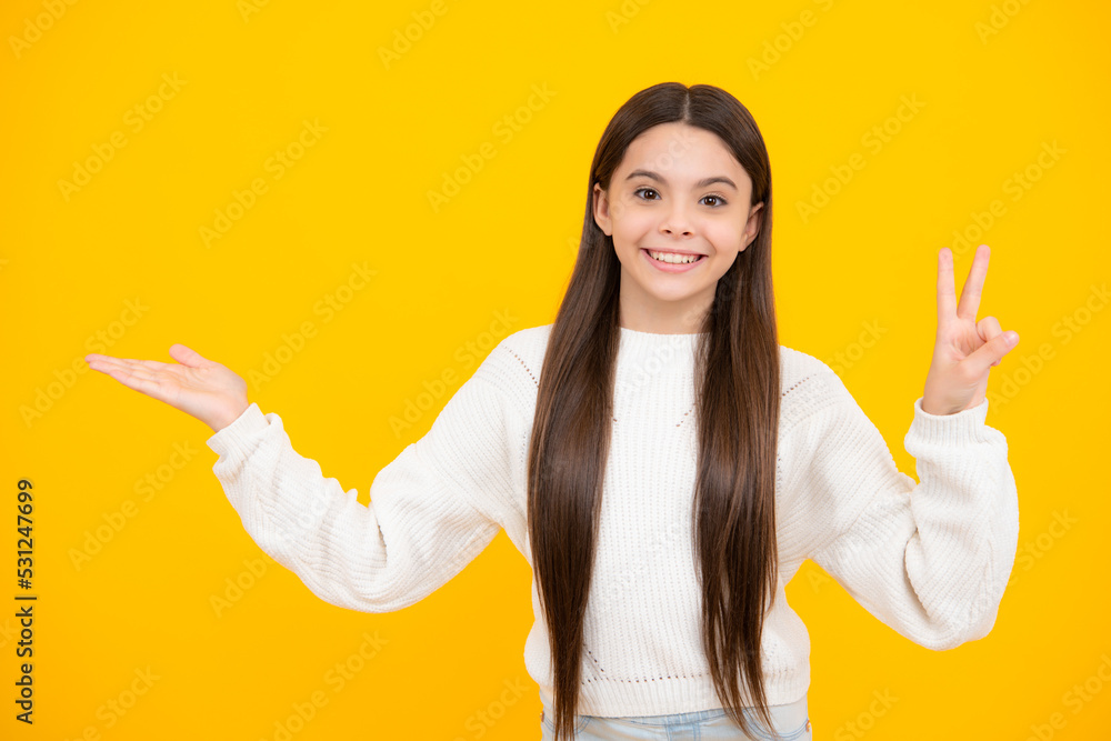 Look at advert. Teenager child points aside shows blank copy space for text promo idea presentation, poses against yellow background. Look at advert. Teenager child points aside shows blank copy space for text promo idea presentation, poses against yellow background.