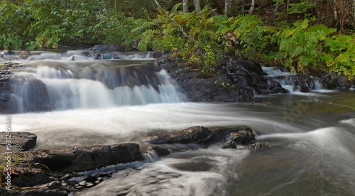 Small cascade in a thick Maine forest © Guy Sagi
