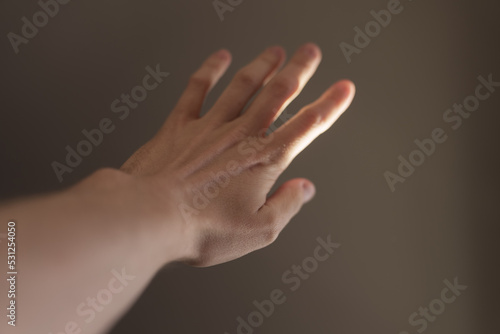 Man hand plays with natural sun light