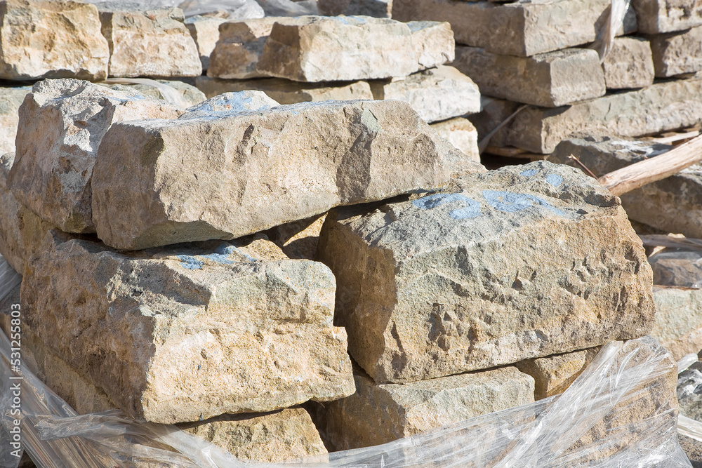 Pile of old sandstone slabs ready to be mounted in a new pavement in a urban construction site Pile of old sandstone slabs ready to be mounted in a new pavement in a urban construction site