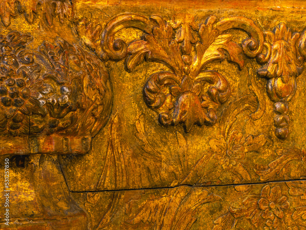 Background of a gilded wooden iconostasis made in the 16th century. The ancient carved iconostasis of the 16th century in Perm is decorated with patterns, images of animals and angels.Religious images