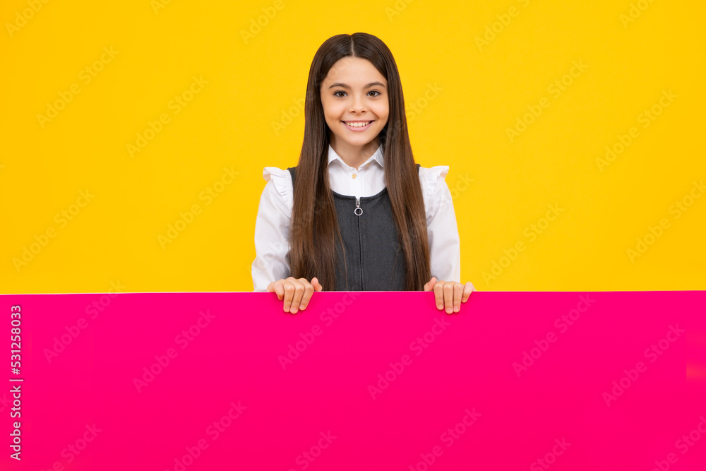 Teenage girl holds a blank for notification informing. Advertisement and sale. Markets and shops sales concept, blank board for copy space. Happy kids face, positive and smiling emotions. Teenage girl holds a blank for notification informing. Advertisement and sale. Markets and shops sales concept, blank board for copy space. Happy kids face, positive and smiling emotions.