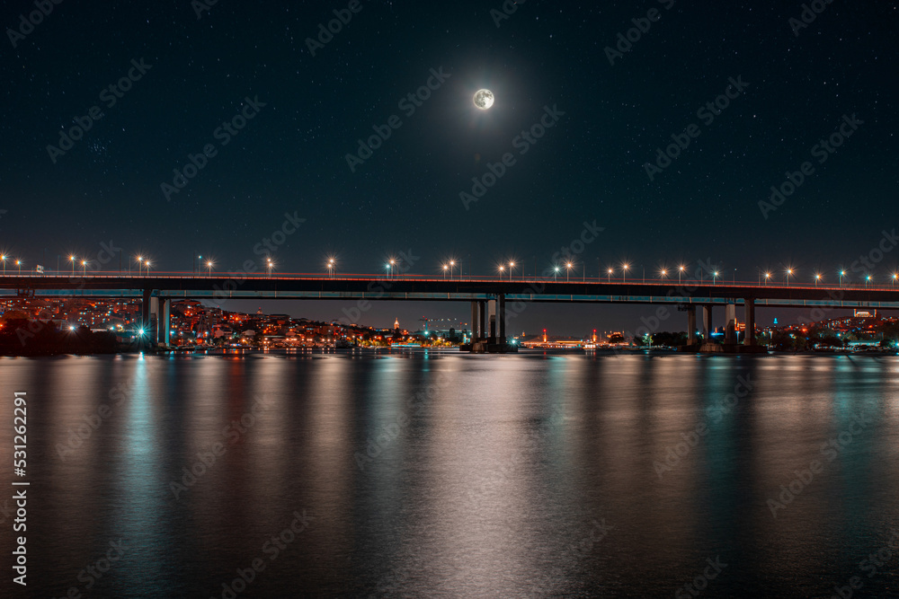 view of the bridge at night with the light of the moon in Istanbul 