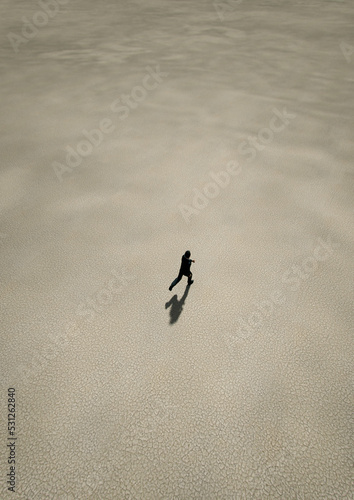 Man in black suit runs in desert. Aerial view. 3D render.