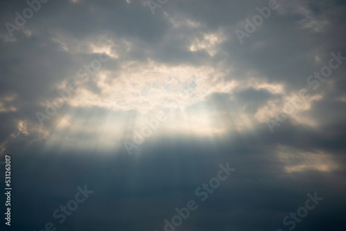 The sun shines through the clouds