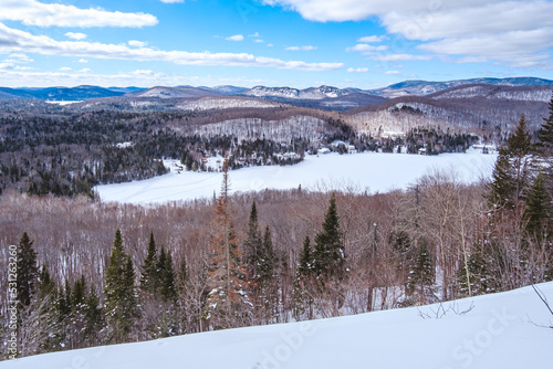 View in winter on the snow covered mountains of Laurentides from the top of Mount Kaaikop in Quebec (Canada)