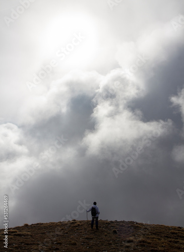 Hiker on the summit of a mountain with snow