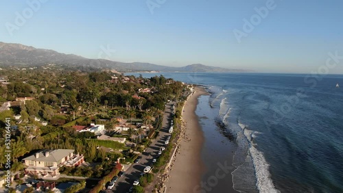 Aerial perpendicular to Santa Barbara coastline and ocean front homes