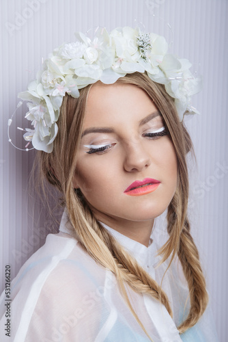 Art caucasian fashion model wearing flory hair hoop with closed eyes. Studio shot. photo