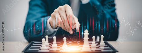 Business strategy competitive ideas concept, Chess game on chess board behind business background. Business present financial and marketing strategy analysis. Investment target in global economy .