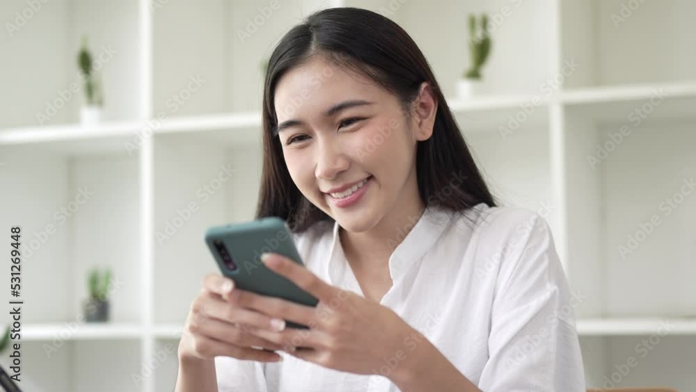 Closeup video of a beautiful young asian woman holding and using mobile phone. Closeup video of a beautiful young asian woman holding and using mobile phone.