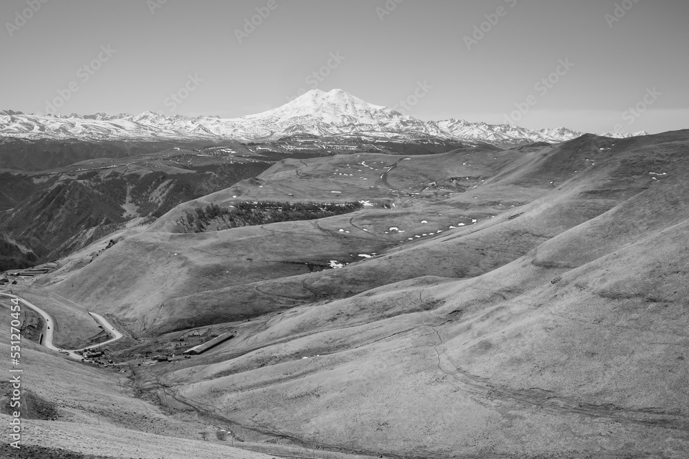 Black white panorama of Mount Elbrus against the backdrop of the Main Caucasian Range. Karachay-Cherkessia. Russia.