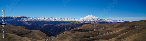 Panorama of Mount Elbrus against the backdrop of the Main Caucasian Range. Karachay-Cherkessia. Russia.
